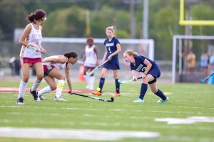 Kendall Herring eliminates the Unity Reed defender by lifting the ball over her stick.